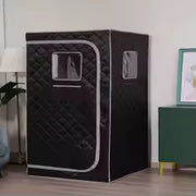 Sauna vapeur portable noir installé dans une pièce de maison avec cabine individuelle pliable
